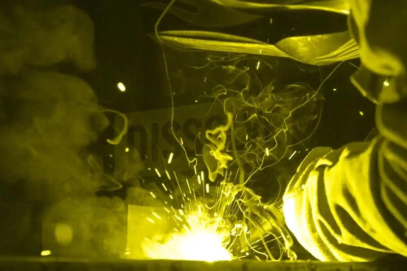 Industrial welding with sparks under protective shield, emphasising Pryme workplace safety and protective gear in Australia.