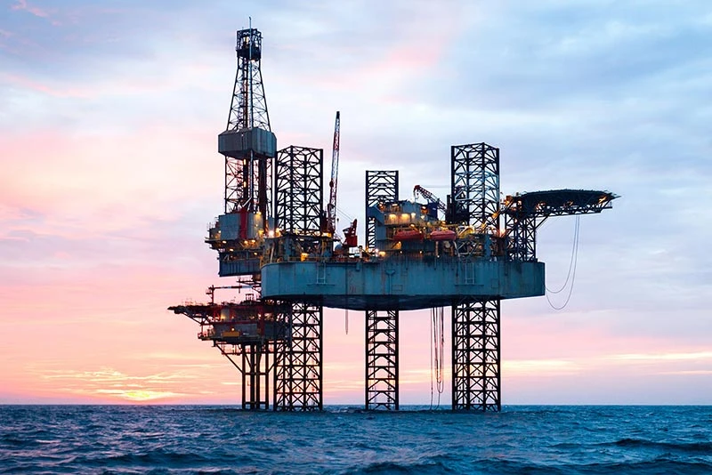 Offshore oil rig at sunset, highlighting workplace safety and working at heights equipment provided by Pryme Australia.