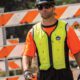Worker wearing Ergodyne Chill-Its 6685 hi-vis cooling vest on a worksite for heat protection.