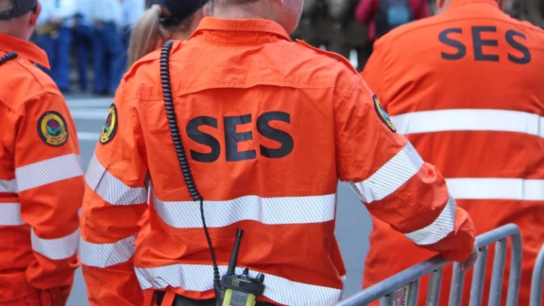 State Emergency Service workers wearing orange uniforms and safety gear during field operation.